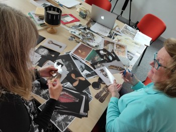 participants cutting out photos of artefacts from Stromness Museum collection, ready to bring them to life.