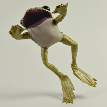 Pictured is a handsewn toad, it is positioned mid-jump.  It has metallic green/gold body with a white underbelly.  It's mouth is open wide. 